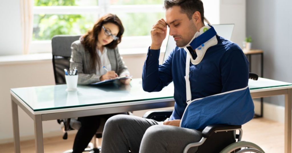Man in wheelchair with personal injury talking to an attorney